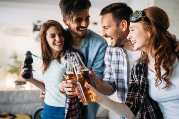 Cheerful friends having party and drinking beer