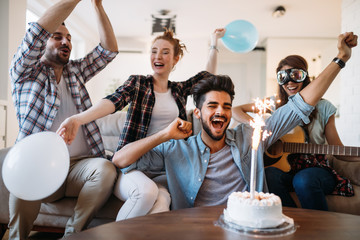 Cheerful young friends having fun on party