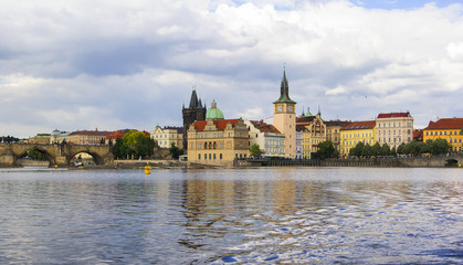 Fototapeta premium Background panoramic view of the embankment of the Vltava River from the water, Prague, Czech Republic