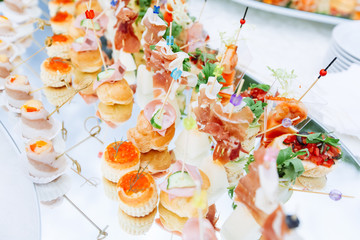 Naklejka na ściany i meble Beautifully decorated catering banquet table with different food snacks and appetizers