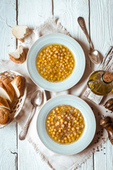 Greek chickpea soup in the white wooden table top view