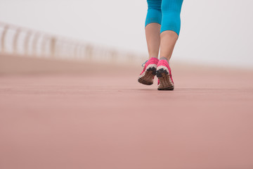 woman busy running on the promenade