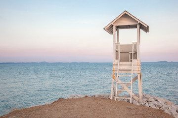 lifeguard stand beside the beach in the evening scene