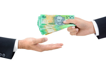 Businessman hands passing money, Australian dollar (AUD) banknotes, isolated on white background