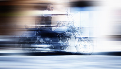 Traffic of vehicle with motion blur. Serious Bearded Biker Man rides a motorbike.
