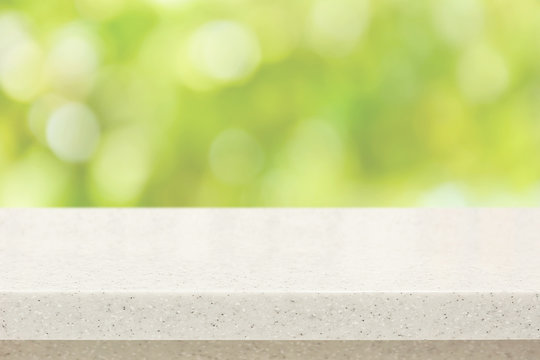 White Quartz Stone Countertop On Bokeh Green Background