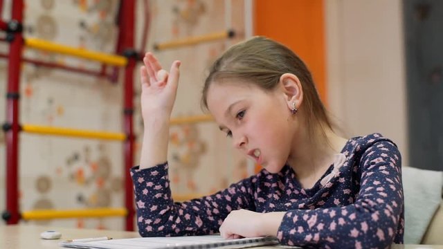A girl of 8 years of age studies at home on mental arithmetic