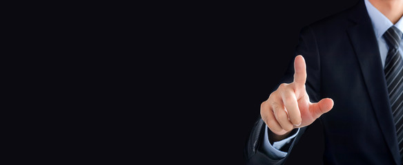 Businessman hand pointing on empty space on black background