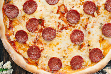 Pizza background - macro shot of pepperoni pizza