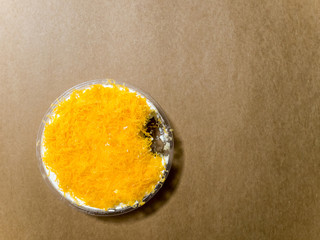 top view of an incomplete golden threads cake on brown background