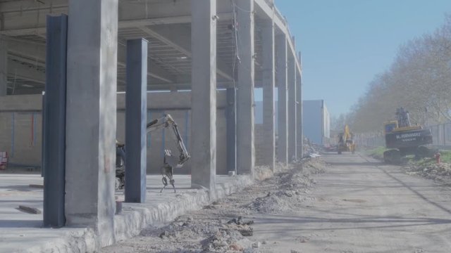 Motion stabilized in construction of industrial warehouse and excavator