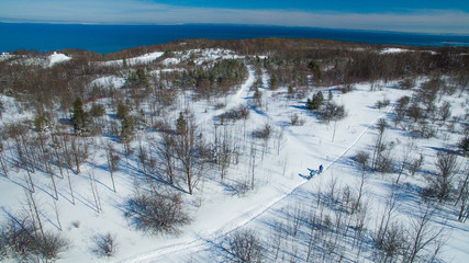 Aerial photo of a couple riding fat bikes in the snow