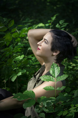 Pretty young girl posing outdoor in a forest