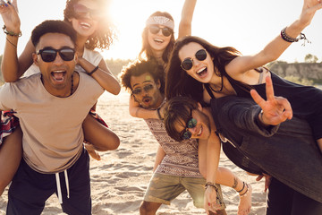 Three beautiful young couples walking along the beach