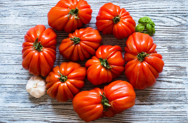 Ox heart tomatoes, on rustic wood background, free space for text.