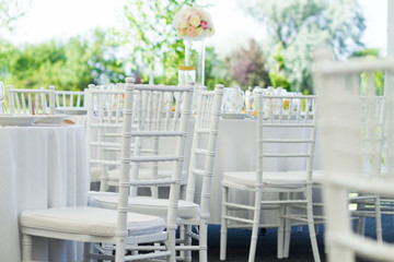 detail of white chairs, fancy wedding decoration