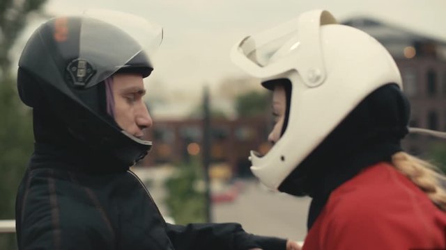 Two skydivers in protective helmets are talking. Skydivers preparing to fly