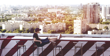 Young man on the roof of a tall building