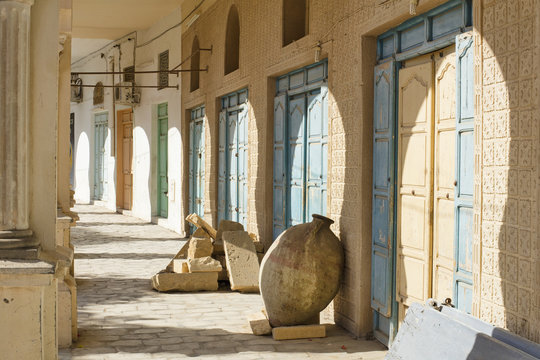 old amphora and shadows under arch in Tunisia city