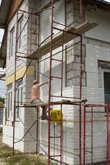 construction worker insulating house facade with mineral rock wool