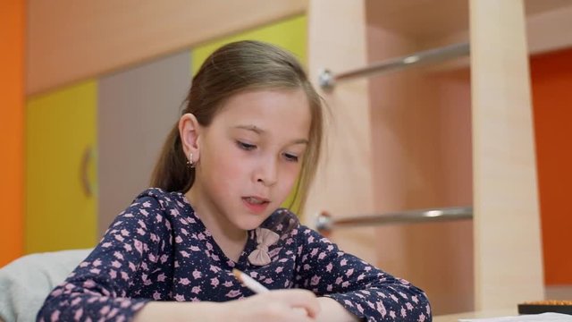 A girl of 8 years of age studies at home on mental arithmetic