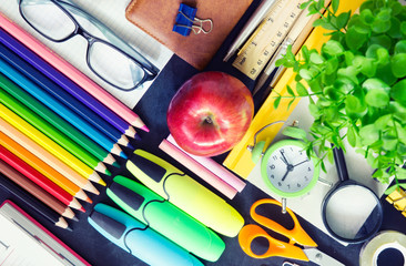 School supplies on school black board.Up view.