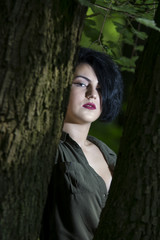Fototapeta premium Pretty young girl posing outdoor in a forest