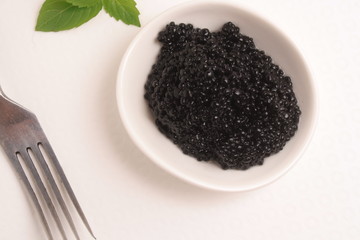 Black caviar on white background