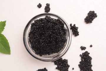 Fototapeta na wymiar Black caviar on white background