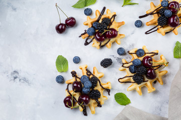 Homemade waffles with chocolate and berries