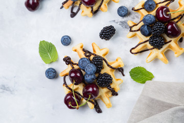 Homemade waffles with chocolate and berries