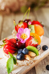 Multigrain rice cakes with berries, fruit and almond for healthy breakfast