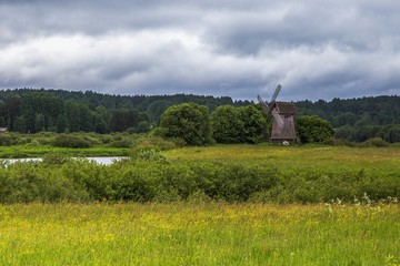 Fototapeta na wymiar Summer rural landscape with a windmill