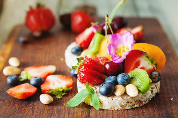 Multigrain rice cakes with berries, fruit and almond for healthy breakfast