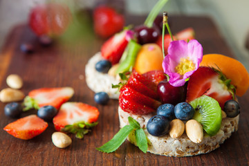 Multigrain rice cakes with berries, fruit and almond for healthy breakfast