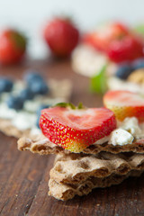 Multigrain rie cakes with berries, fruit and almond for healthy breakfast
