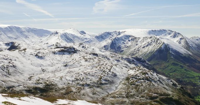 Views of snow covered mountains in the Eastern Fells of the English Lake District. Summits of Hartsop Dodd, Stony Cove Pike as well Brothers Water lake and the road, Kirkstone Pass.