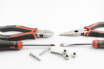 Still life composed of screws, nuts, screwdrivers and forceps.