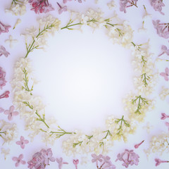 Fototapeta na wymiar Decorative vintage frame made of lilac flowers. View from above.