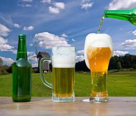 Pouring glass of beer from bottle