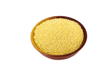 Dry millet in silver bowl isolated on white. Spilled millet.