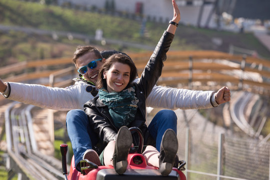 couple enjoys driving on alpine coaster