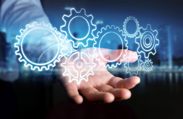 Businessman holding hand-drawn gears icons
