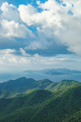 Obraz na płótnie Canvas View of blue sky, sea and mountain seen from Cable Car viewpoint, Langkawi, Malaysia. Picturesque landscape with tropical forest, beaches, small Islands in waters of Strait of Malacca