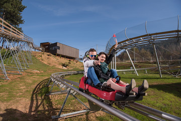 couple enjoys driving on alpine coaster