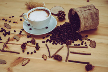 cup of coffee on old wooden desk. Simple workspace or coffee break in morning/ selective focus