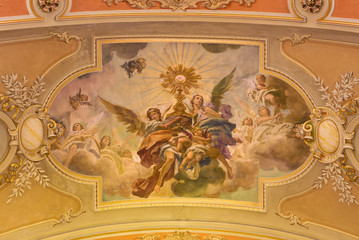 TURIN, ITALY - MARCH 13, 2017: The fresco of Eucharistic adoration of angels in ceiling of church Chiesa di Santo Tomaso by N. Arduino (1938).