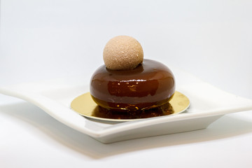 Beautiful dessert: chocolate cake on a white plate close-up. Selective focus. Isolate on a white background