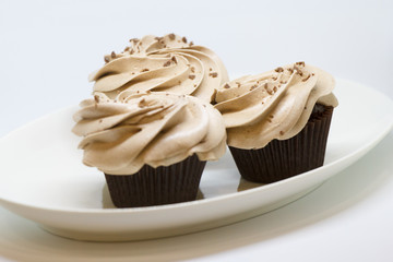 Chocolate cupcakes isolated on white. Selective focus
