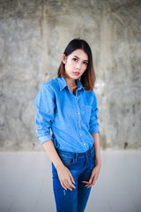 Asian woman casual outfits standing in jeans and blue denim shirt, women brown hair and short hair, beauty and fashion jeans concept